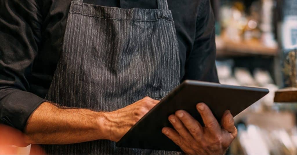 Retail manager using a tablet to improve daily retail operations