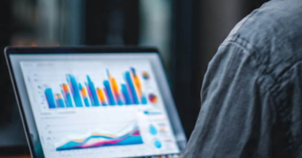 SME owner analyzing a cash flow forecast on a laptop screen