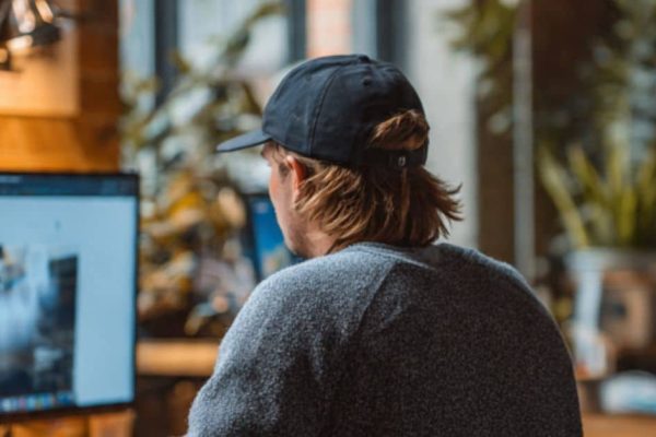 Entrepreneur selecting between Shopify and WooCommerce to build a brand.com site