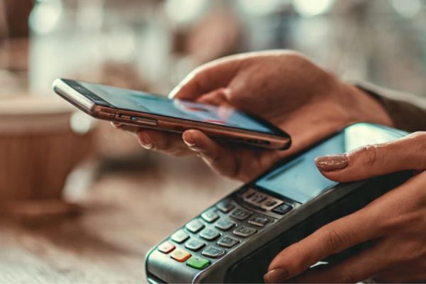 A customer completing a purchase on a mobile phone optimized for checkout and payments