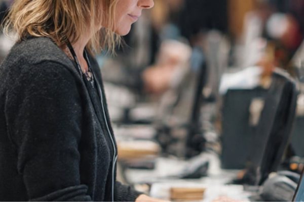 A worker scanning products to track OOS expiry and replenishment cycles