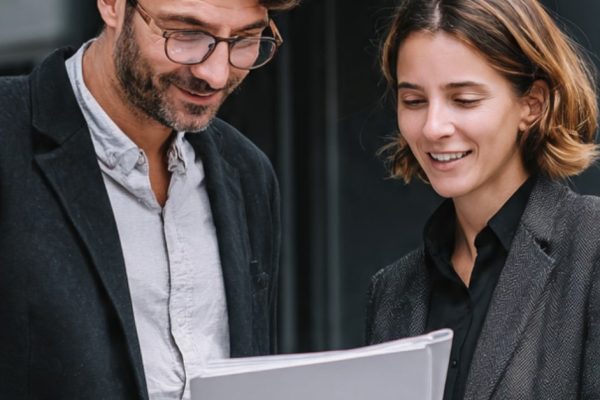 A manager and employee reviewing a newly built employee handbook
