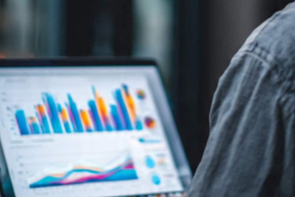 SME owner analyzing a cash flow forecast on a laptop screen